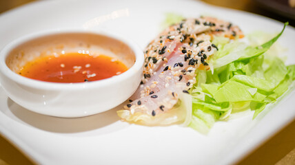 Typical Japanese dish of sushi, rice and fish, with sauce, salad, sushimi and sesame.