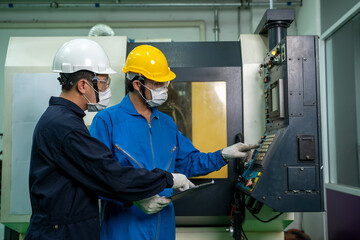 Industrial factory employee working and checking near electric meters panel of a control room in industry factory. © visoot