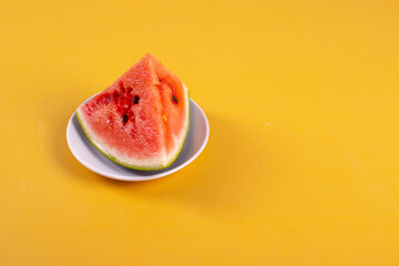 fresh and ripe watermelon on yellow background. minimalism style