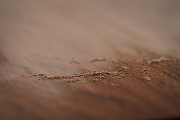 Black walnut table with dust from sanding - obrazy, fototapety, plakaty