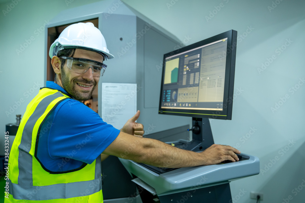 Poster engineer mechanic use laptop working and checking machine in a large industrial factory.