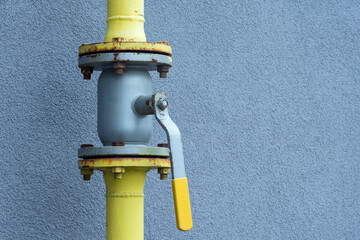 Gas pipe cock on the background of clear wall. Equipment for gas distribution system of...