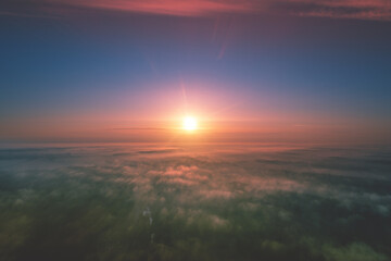 Early misty morning. Sunrise above the clouds. Rural landscape in the early morning. Aerial view