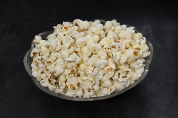 Heap of salted popcorn, isolated on white background.
