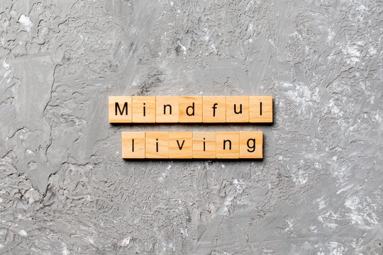 mindful living word written on wood block. mindful living text on table, concept