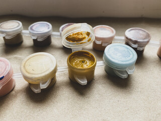 Colors acrylic paints in small jars