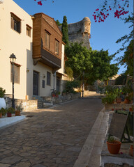 Traditional houses and historic cobbled street leading to historic castle in Rethimno Crete Greece.