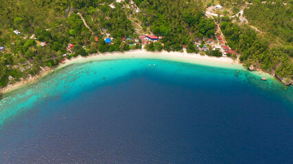 Fototapeta na wymiar Beautiful beach Canibad, palm trees by turquoise water view from above. Philippines,Samal island.