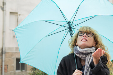 woman with foulard and umbrella in autumn