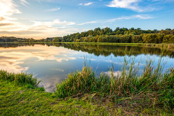 Fototapeta na wymiar Lake at sunset. Countryside rural scenery in Poland