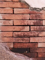 Old brick wall texture background. Shabby Building Facade With Damaged Plaster.