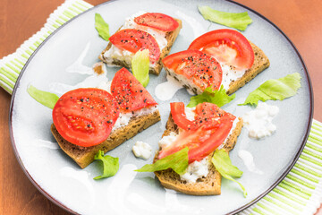 Eating healthy - sourdough bread with cottage cheese and tomato