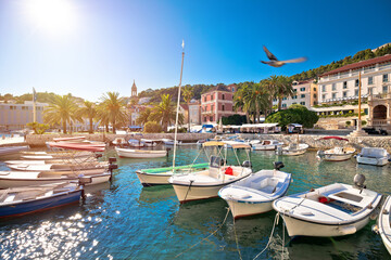 Fototapeta na wymiar Turquoise waterfront and harbor of old town of Hvar sun haze view