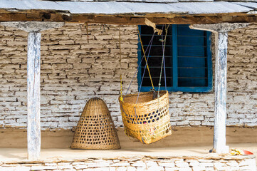 Cradle hanging in front of a house, Dhampus mountain village, Nepal,