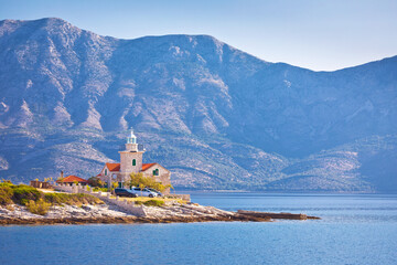 Lighthouse of Sucuraj on Hvar island and Biokovo mountain background view