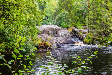 Naklejka na ściany i meble Park with the cascades of Akparhvenkoski waterfalls on the Tokhmayoki River, a popular tourist attraction situated near the settlement Ruskeala in Karelia, Russia
