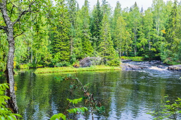 Park with the cascades of Akparhvenkoski waterfalls on the Tokhmayoki River, a popular tourist attraction situated near the settlement Ruskeala in Karelia, Russia