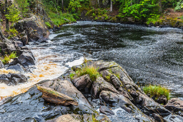 Fototapeta premium Park with the cascades of Akparhvenkoski waterfalls on the Tokhmayoki River, a popular tourist attraction situated near the settlement Ruskeala in Karelia, Russia
