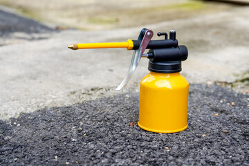 Closeup of a yellow motor oil spray can