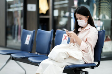 Asian women with surgical face mask to protect the Covid-19 in airport