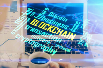 Double exposure of blockchain theme hologram and table with computer background. Concept of bitcoin...