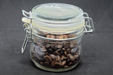 coffee beans in a glass jar with a closing lid