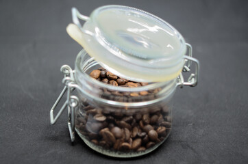 coffee beans in a glass jar with a closing lid