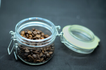 Coffee beans in a mirror jar .