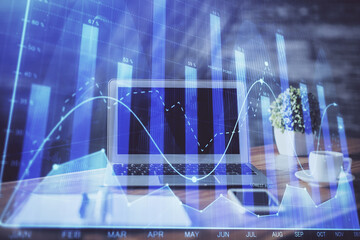 Stock market graph and table with computer background. Multi exposure. Concept of financial analysis.