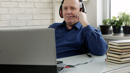 Image with a Person Using a Laptop and Headphones for an Online Video Conference