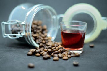 Alcoholic drink next to coffee beans .
