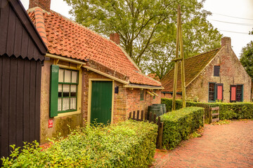 Fototapeta na wymiar Old typical Dutch fisherman's cottages from the 1920s in the open air museum in Enkhuizen.