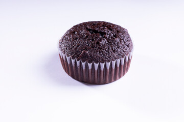 plain dark chocolate cupcakes in paper cups on white background - side View
