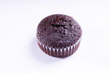 plain dark chocolate cupcakes in paper cups on white background - side View
