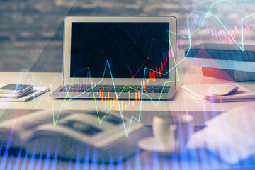 Financial graph colorful drawing and table with computer on background. Multi exposure. Concept of...