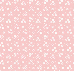 Vintage floral background. Seamless vector pattern for design and fashion prints. Flowers pattern with small white flowers on a pink background. Ditsy style.
