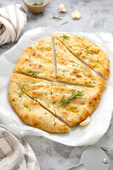 Freshly baked flat garlic bread, foccacia with olive oil and herbs.