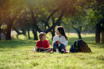 School Children is sitting on the park in sunny day. Students and education, young people at schoo