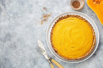 Obraz na płótnie Canvas Uncooked squash or pumpkin tart, cooking autumn dessert. Homemade pastry