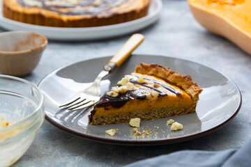 Slice of pumpkin pie. Top view of squash tart. Homemade autumn food.