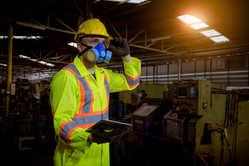 Engineer industry wearing safety uniform ,black gloves and gas mask under checking chemical tank in...