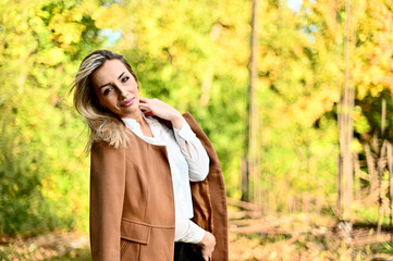 young woman in park on sunny autumn day 