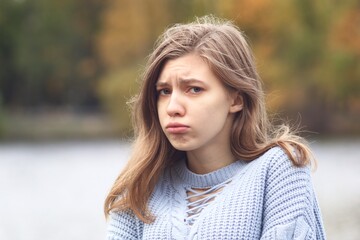  Portrait of sad upset offended young woman, frustrated teenager girl looking at camera with angry...
