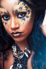 beauty afro girl with cat make up, creative leopard print on face closeup halloween woman