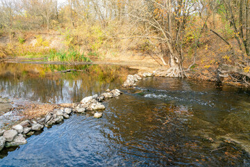 autumn forest and river landscape with blue sky background