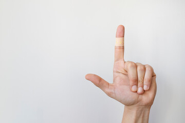 Band Aid. A bandage on a man's finger