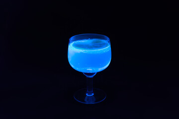 Glass of tonic with lemon glowing in UV