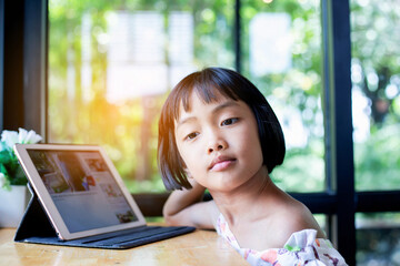 Happy kids using a laptop computer at home