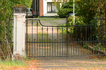 Ancient steel closed gate that gives access to a house