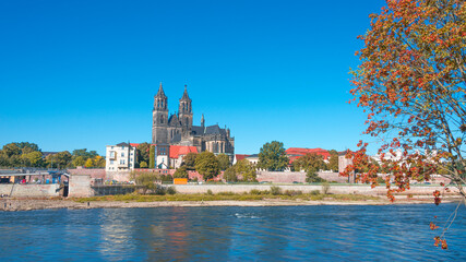 Panoramic view over downtown of Magdeburg, old town, Elbe river and Magnificent Cathedral at early Autumn, Germany, at sunny day and clear blue sky.
